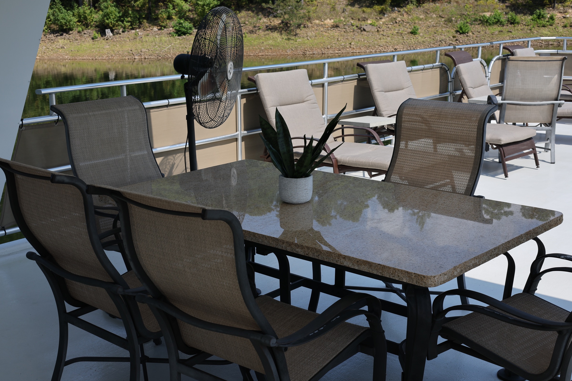 Upper-deck dining table and lounge seating overlooking Lake DeGray