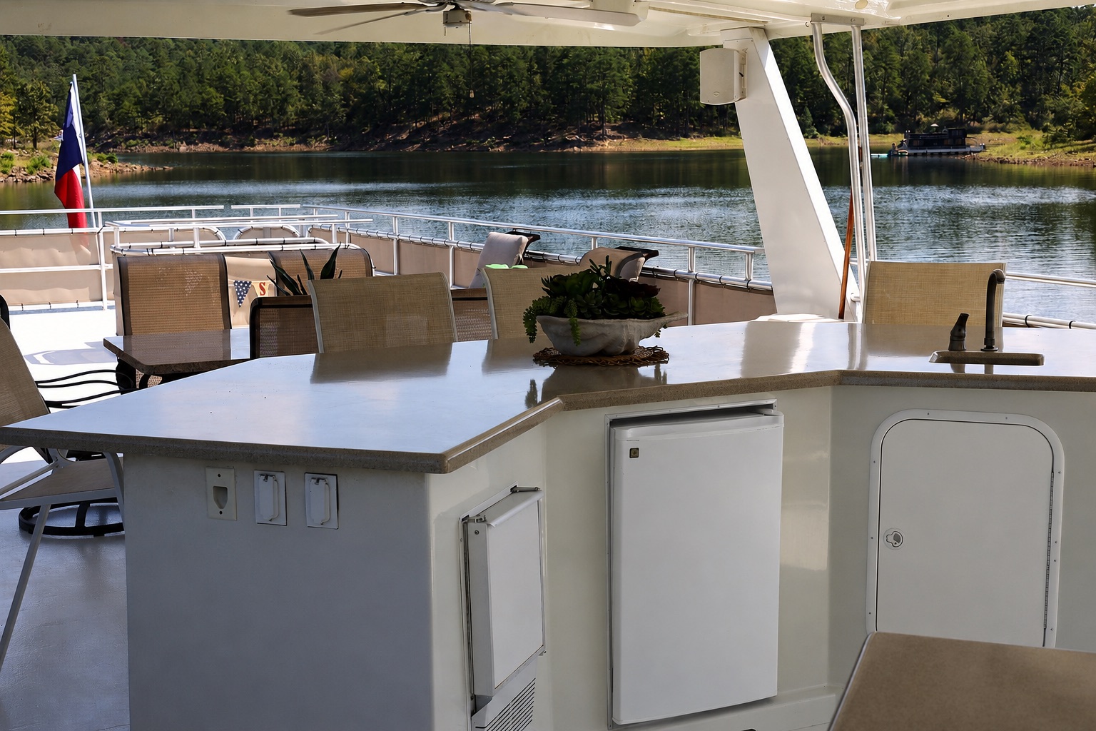 Upper-deck wet bar with refrigerator, sink, and lake view