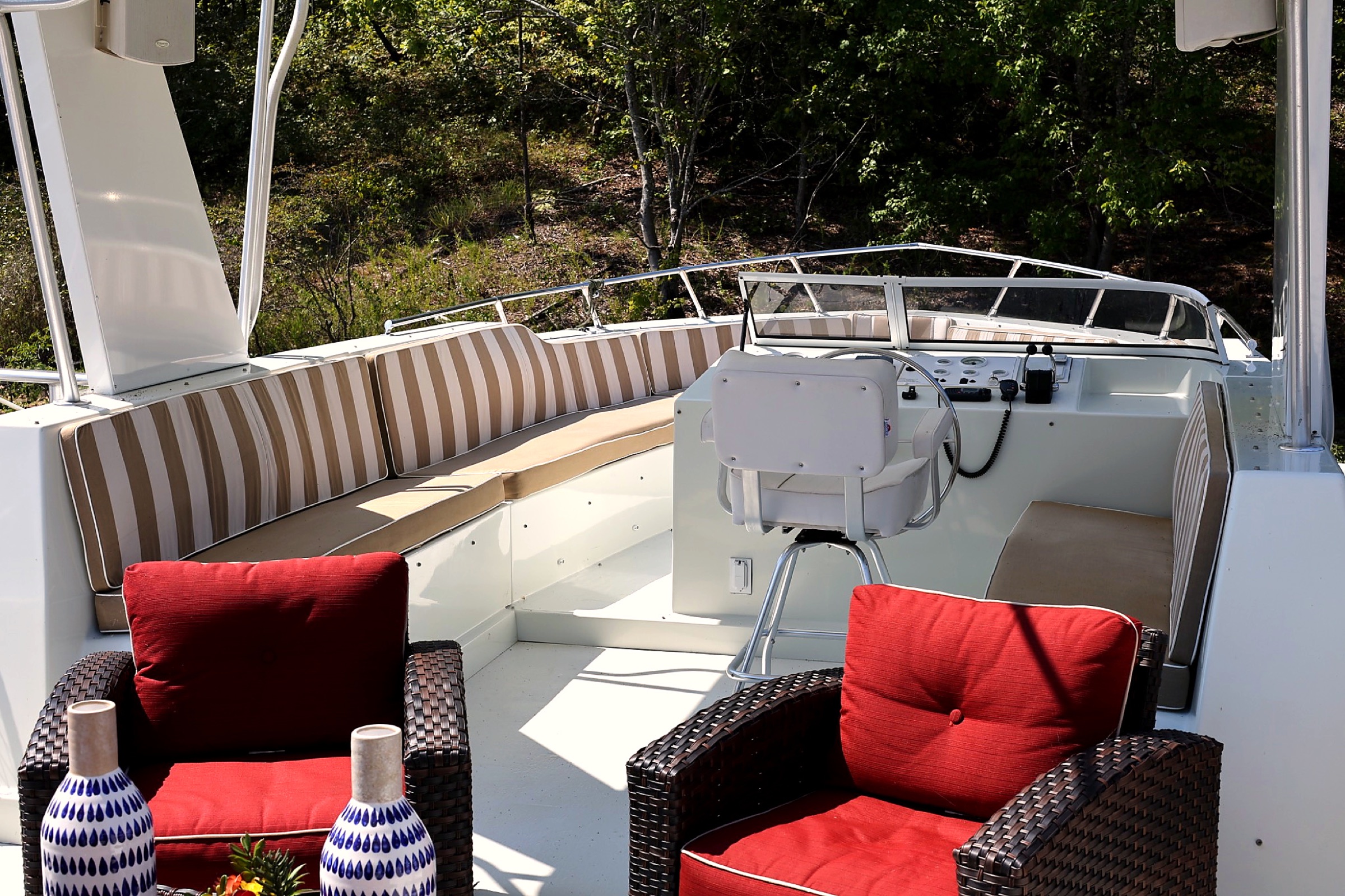 Sunlit upper helm with red-cushioned lounge chairs