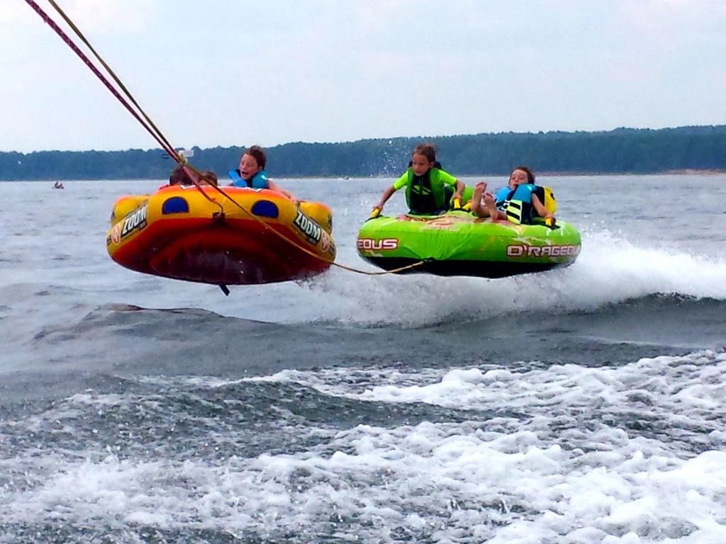 Family tubing behind the houseboat on Lake DeGray