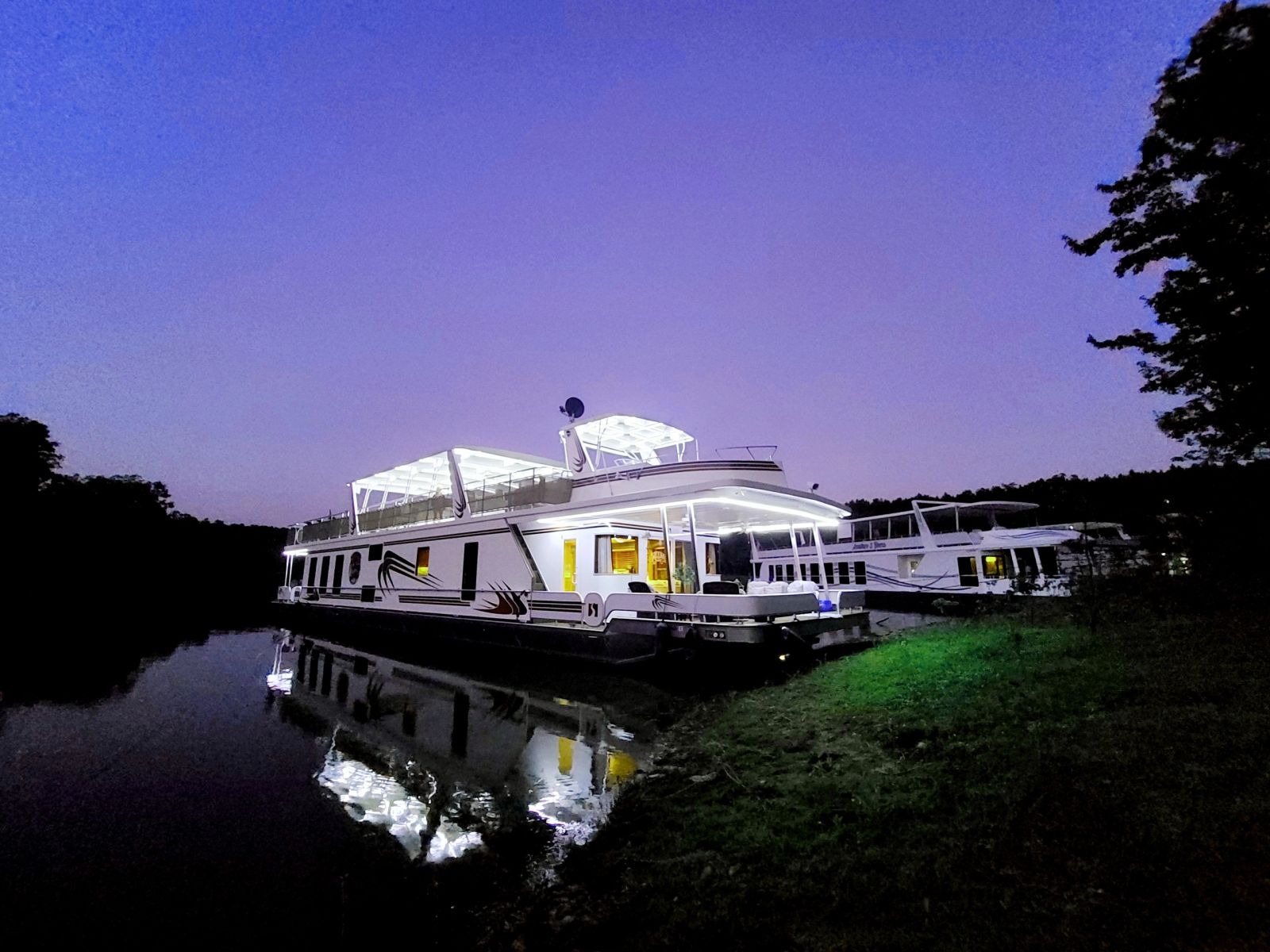 Sharpe houseboat illuminated on Lake DeGray at night