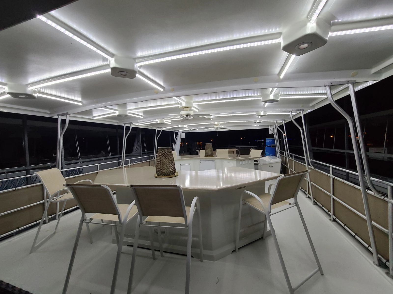Upper-deck dining table beneath the covered roof