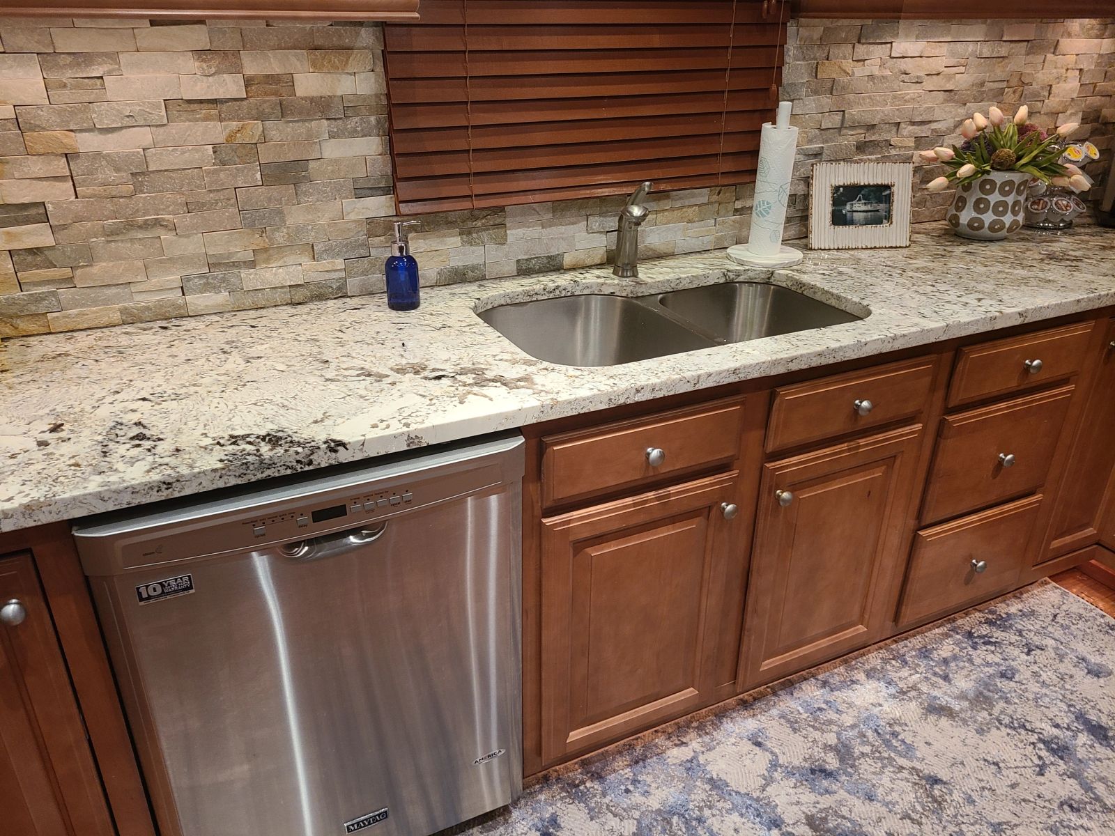 Granite kitchen counters, sink, and dishwasher