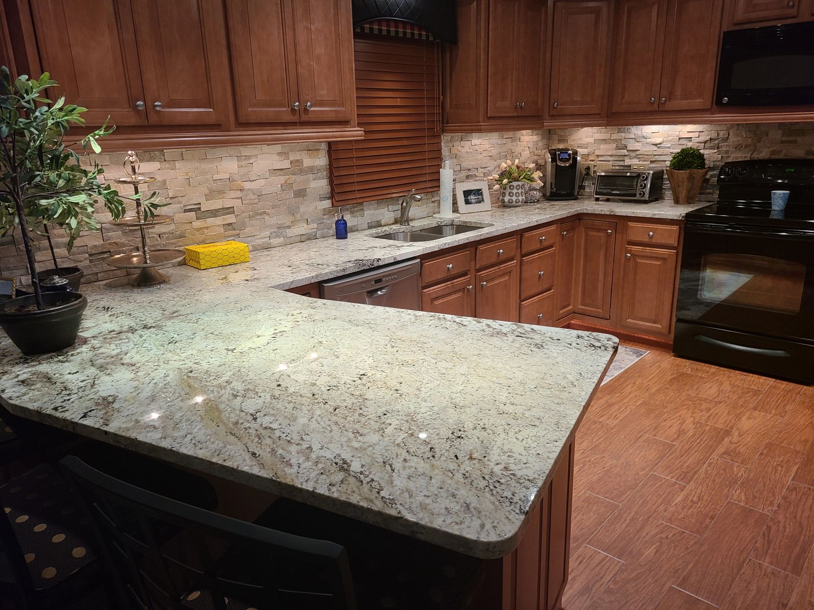 Full kitchen with granite island and wood cabinetry