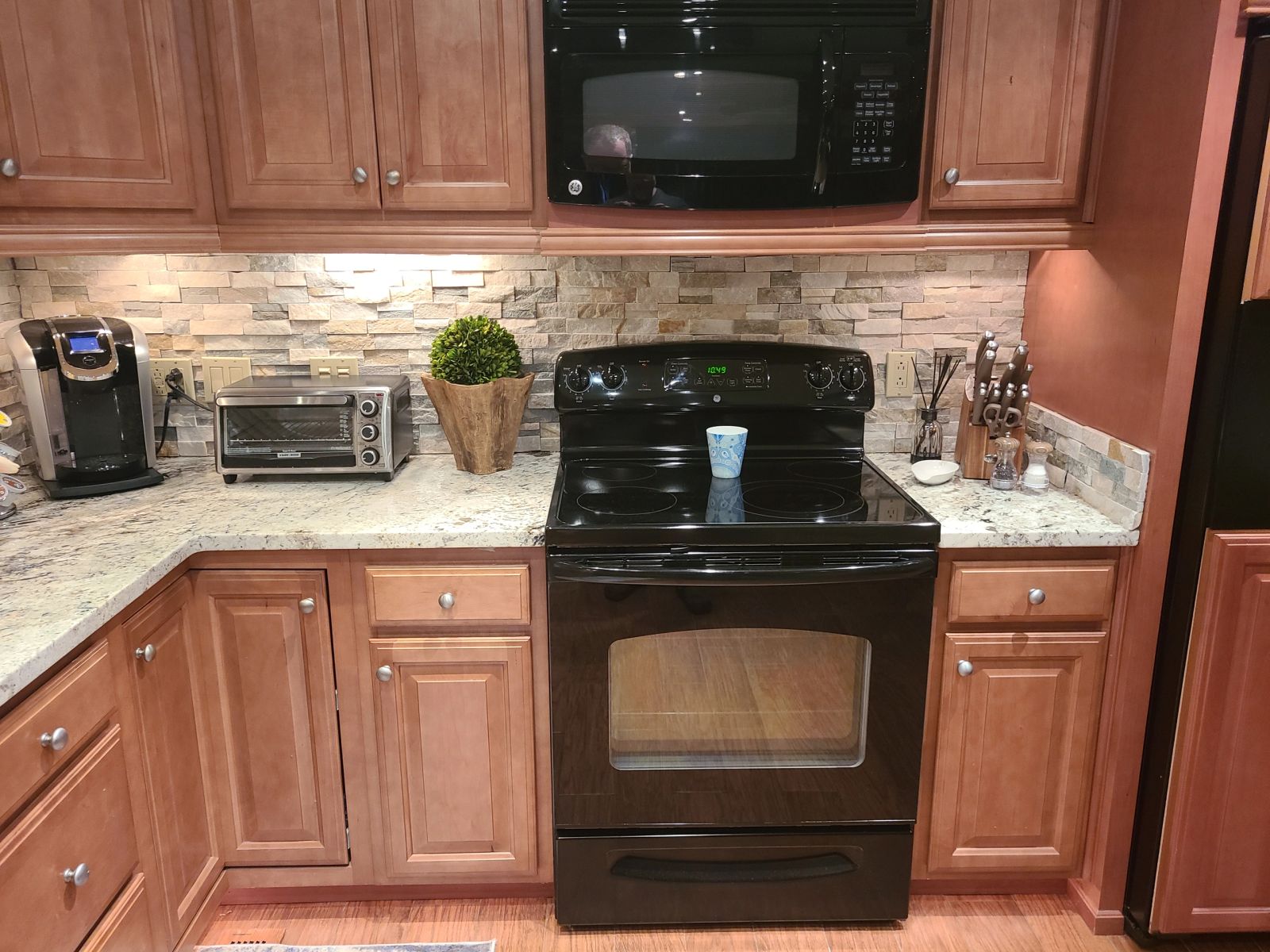 Residential kitchen range, microwave, and storage