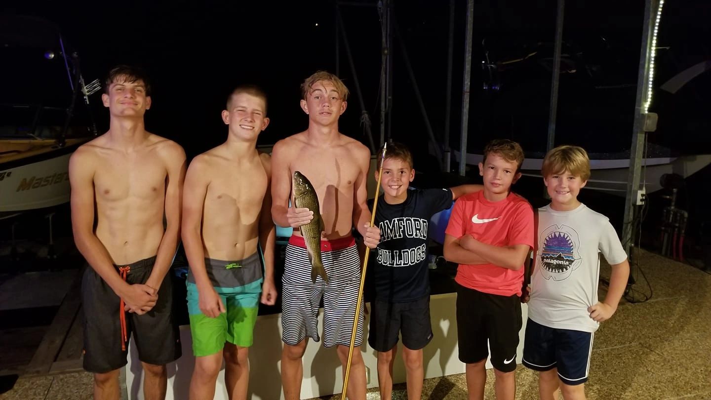Family gathering after dark at the marina