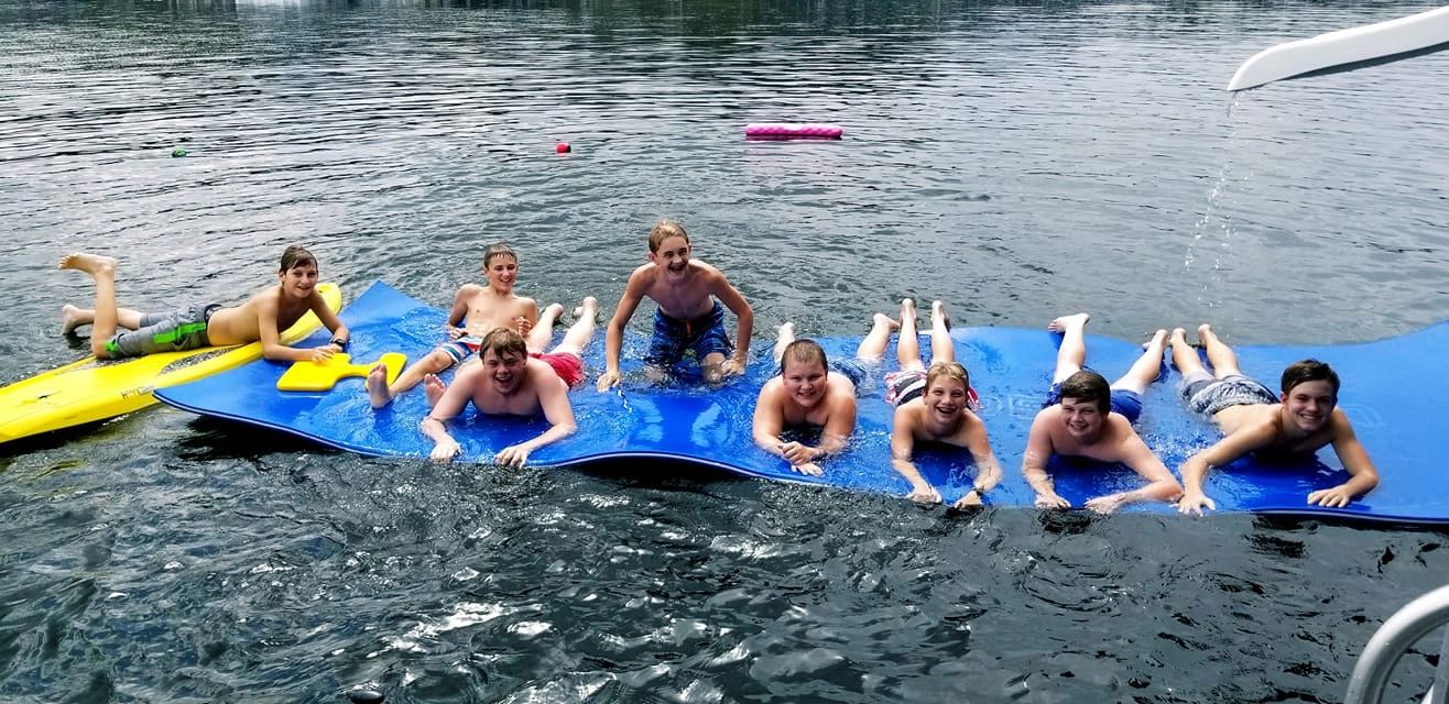Group swimming beside the houseboat on Lake DeGray